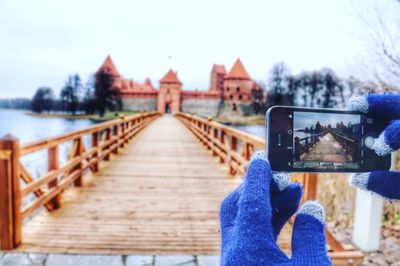 Close-up of person photographing with mobile phone in winter