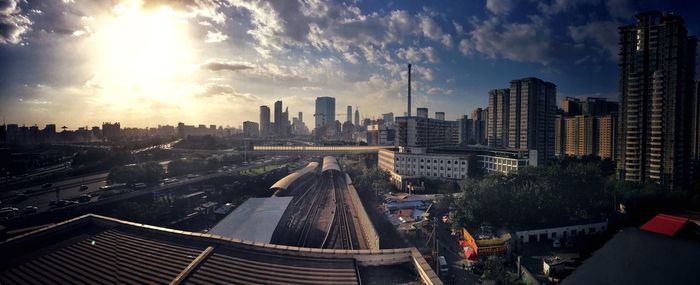 View of cityscape against cloudy sky