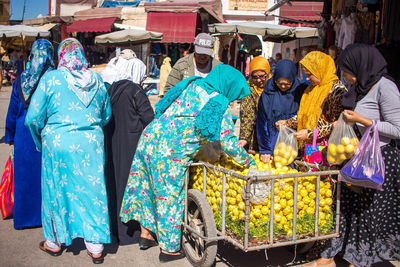 Group of people for sale at market stall