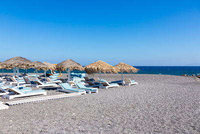 Panoramic view of beach against clear blue sky