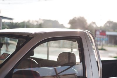 Close-up of car on road against sky