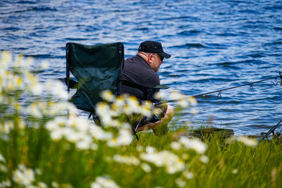 Rear view of man standing in sea