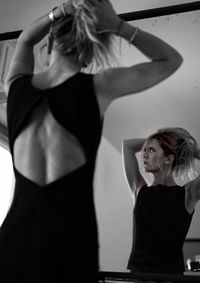 Midsection of woman standing against wall