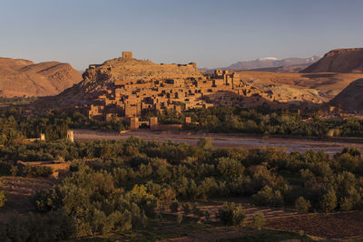 Scenic view of old town and mountains against clear sky