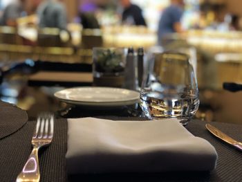 Close-up of glasses on table in restaurant