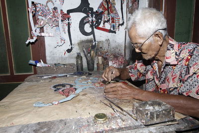 Portrait of man sitting on table