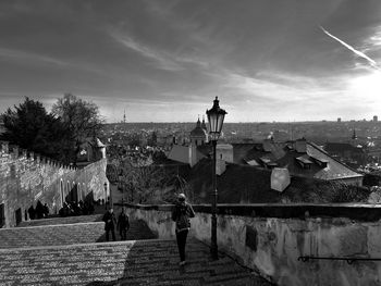 People on street amidst buildings against sky