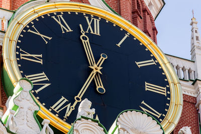 Low section of clock tower against buildings in city