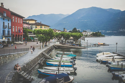 Boats in sea with town in background