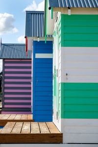 Multi colored beach huts against sky