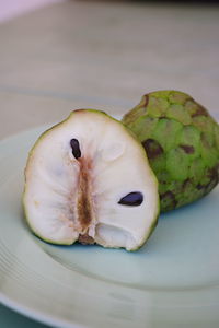 Close-up of chopped fruit in plate on table