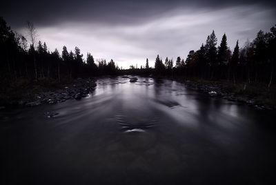 Scenic view of lake against sky at forest