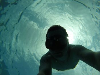 Self portrait of man free diving undersea