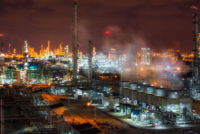 High angle view of illuminated buildings against sky at night