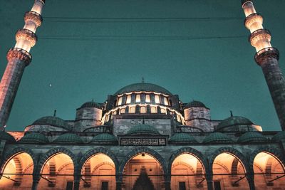 Low angle view of illuminated building against sky