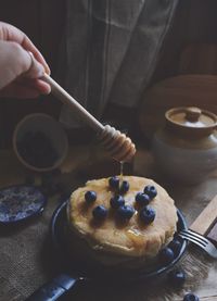 Close-up of hand holding coffee cup
