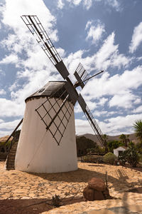 Traditional windmill against sky