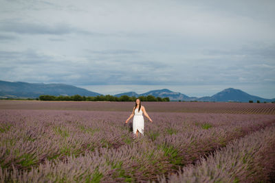 Woman standing on land against sky