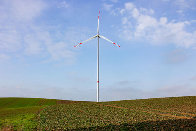 Low angle view of windmill against sky