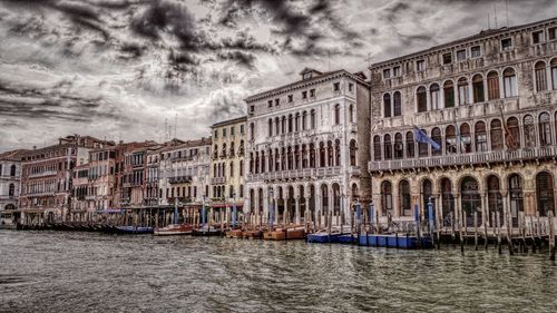 Buildings against cloudy sky