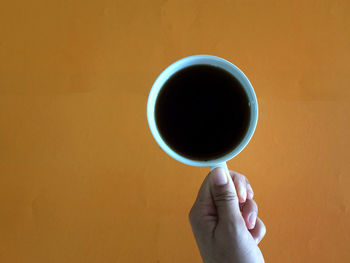 Person holding coffee cup