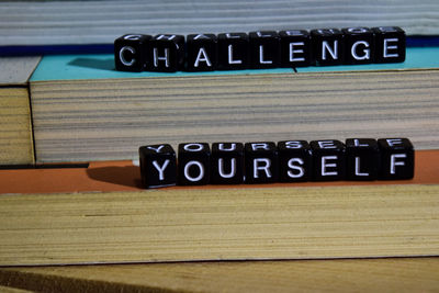 Close-up of text on wooden table