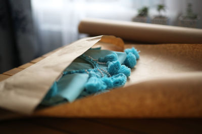 Woman packs a handicraft thing into craft paper, a small business and customer care