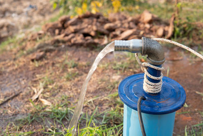 Close-up of water pipe on field