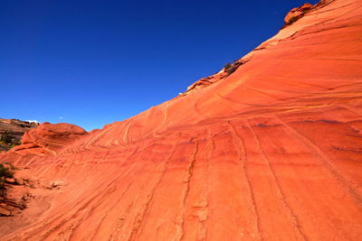 Scenic view of desert against clear blue sky