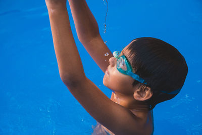 High angle view of boy swimming in pool