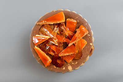 High angle view of orange fruit against white background