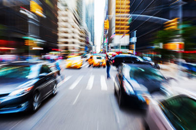 Blurred motion of cars on road in city