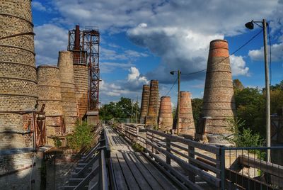 View of factory against cloudy sky