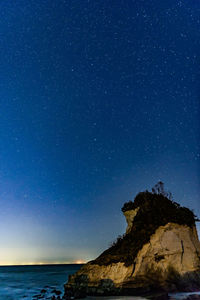 Scenic view of sea against star field at night