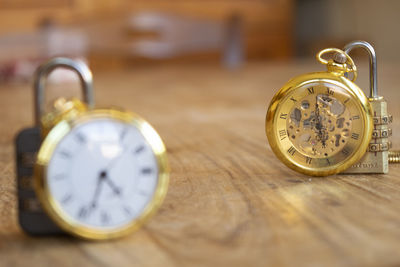 Close-up of pocket watch on wooden table