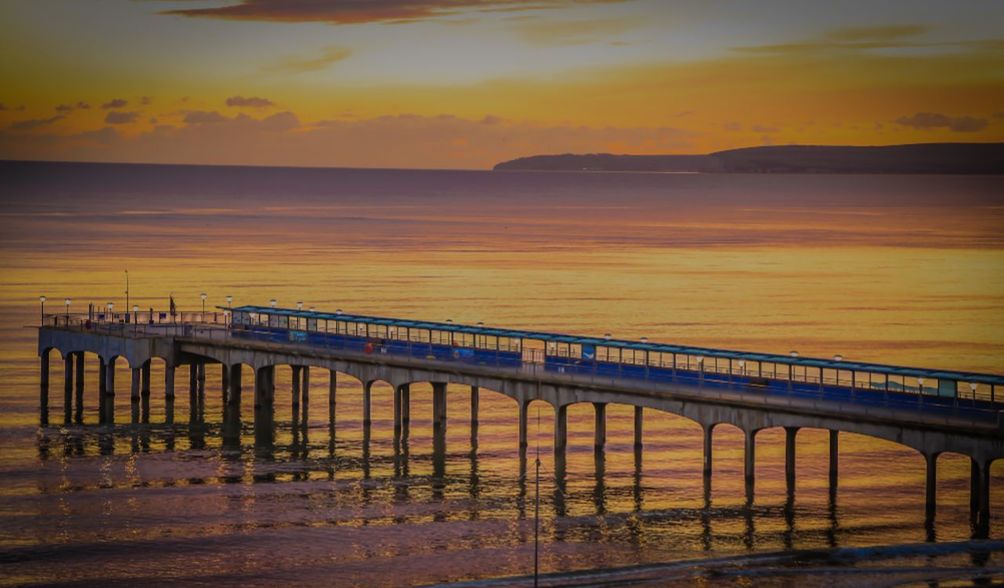 SCENIC VIEW OF BEACH AT SUNSET