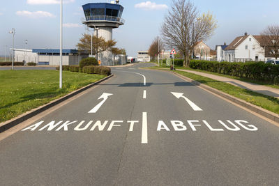 Information sign on road by buildings in city