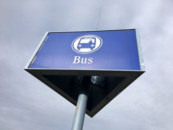 Low angle view of road sign against sky