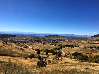 Countryside landscape against clear blue sky