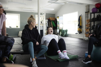 Group of happy people resting in gym