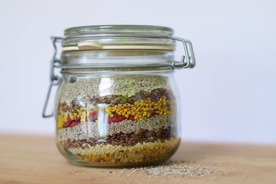 Close-up of various seeds in jar on table