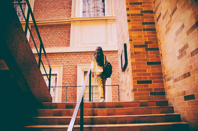 Man and woman walking on staircase of building