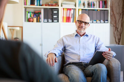 Full length of man sitting on book