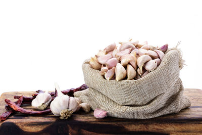 Close-up of garlic on table against white background