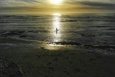 Scenic view of beach against sky during sunset