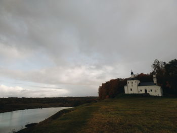 Scenic view of lake by building against sky