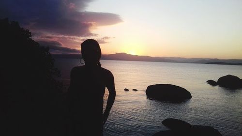 Rear view of woman looking at sunset