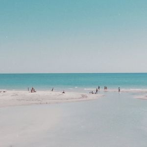 People on beach against sky