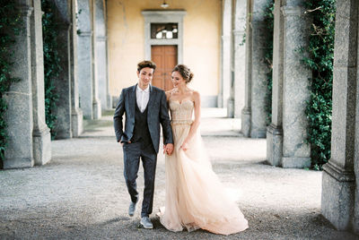 Full length of bride standing in city