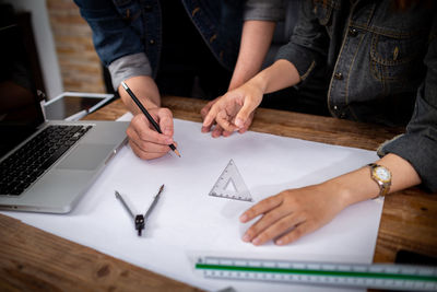 High angle view of people working on table